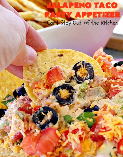 Jalapeno Taco Party Appetizer | Can't Stay Out of the Kitchen | the best #TexMex layered dip ever! This one uses refried beans with jalapenos, #avocados, a sour cream & #taco seasoning layer. Then it's topped with olives, #cheese, green onions and tomatoes. Perfect for #tailgating or #SuperBowl parties. #appetizer