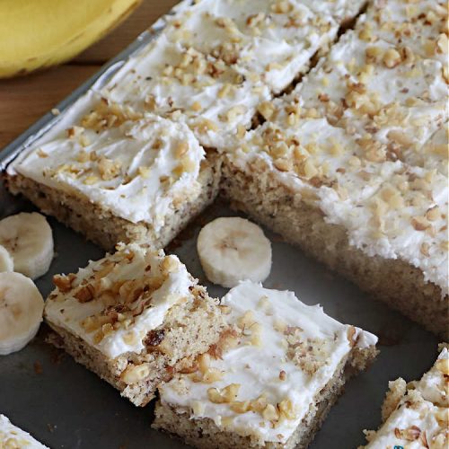 Banana Nut Bars | Can't Stay Out of the Kitchen | Be prepared to swoon over these delectable bar-type #cookies. The #brownie is made with #bananas, #walnuts & #SourCream. The #CreamCheeseIcing includes more #nuts on top. They'll cure every sweet tooth craving. Great for #potlucks, #BackyardBarbecues or anytime you have an abundance of #OverripeBananas! #dessert #BananaDessert #BananaNutBars