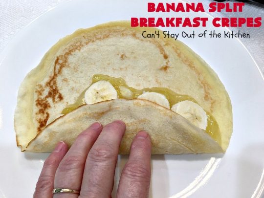 Banana Split Breakfast Crêpes | Can't Stay Out of the Kitchen | these spectacular #breakfast #crêpes will rock your world! They're filling with a #pineapple filling & sliced #bananas. Then garnished with #walnuts, bananas #MaraschinoCherries & whipped cream. Perfect for a company or #holiday breakfast. #BreakfastCrêpes #BananaSplit #BananaSplitBreakfastCrêpes