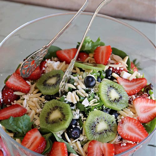 Berry Tossed Salad | Can't Stay Out of the Kitchen | this lovely #TossedSalad with #fruit includes #strawberries, #blueberries, #kiwi, #FetaCheese & slivered #almonds. The #SaladDressing includes #RaspberryJam & it sets the #salad off perfectly. If you enjoy fruity salads, this one is spectacular & is calling your name! Great company or #holiday salad too. #BerryTossedSalad #GlutenFree