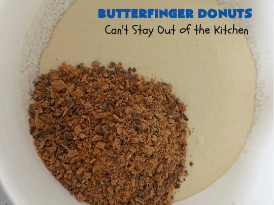 Butterfinger Donuts | Can't Stay Out of the Kitchen | Prepare to swoon over every delicious bite of #ButterfingerDonuts! These luscious #donuts include #Butterfingers in the donut as well as on top of the #ChocolateFrosting. Every bite will rock your world! Terrific for a weekend, company or #holiday breakfast or #brunch. #HolidayBreakfast #BakedDonuts #ButterfingerCandyBars