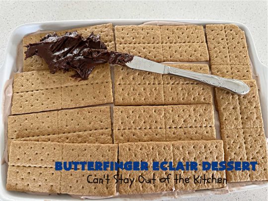Butterfinger Éclair Dessert | Can't Stay Out of the Kitchen | this spectacular #ButterfingerÉclairDessert uses only 6 ingredients & is the perfect #dessert for company or #holidays. It serves a crowd & everyone enjoys the #GrahamCracker, #ChocolatePudding & #ChocolateFrosting layers that mimic Éclairs. You & your friends will swoon over this delicious #ButterfingerDessert. #Chocolate #ChocolateDessert #ButterfingerCandyBars