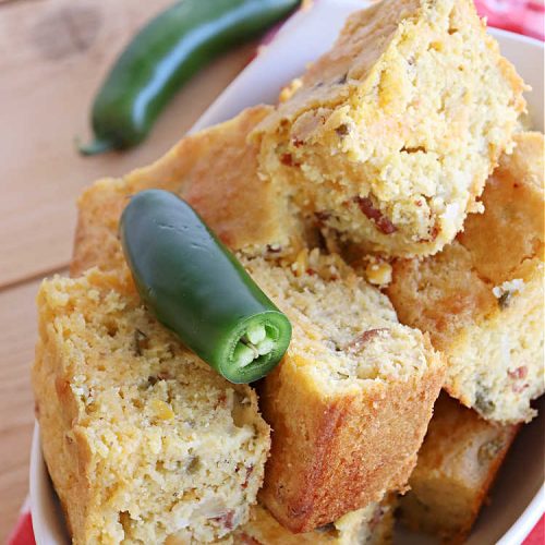 Cheesy Mexican Cornbread | Can't Stay Out of the Kitchen | this delectable & savory #cornbread includes #bacon, a layer of #CheddarCheese, & #GreenChilies to give it a little punch. It pairs wonderfully with soup or chili. Buttermilk & sour cream keep it moist so it doesn't crumble when you're eating it. Great side for any occasion. #TexMex #CheesyMexicanCornbread