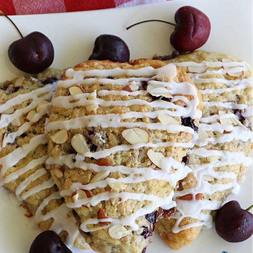 Cherry Almond Scones | Can't Stay Out of the Kitchen | #CherryAlmondScones are outrageously good & terrific for any kind of company or #holiday #breakfast like #Thanksgiving, #Christmas or #ValentinesDay. These #scones are filled with #cherries, #AlmondExtract & #almonds & glazed with a luscious #almond icing. Every bite will have you swooning! #HolidayBreakfast