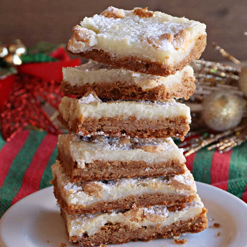 Gingerbread Ooey Gooey Bars | Can't Stay Out of the Kitchen | these delicious bar-type #cookies have all the classic flavors of #OoeyGooeyBars but with a #Gingerbread flavor instead! A #GingerbreadCakeMix is used for the crust layer. It's topped with a #CheeseCake layer, #WhiteChocolateChips & sprinkled with #PowderedSugar. Every bite will knock your socks off! Great for #Christmas or #holiday parties, #tailgating or a #ChristmasCookieExchange. #dessert #GingerbreadDessert #GingerbreadOoeyGooeyBars