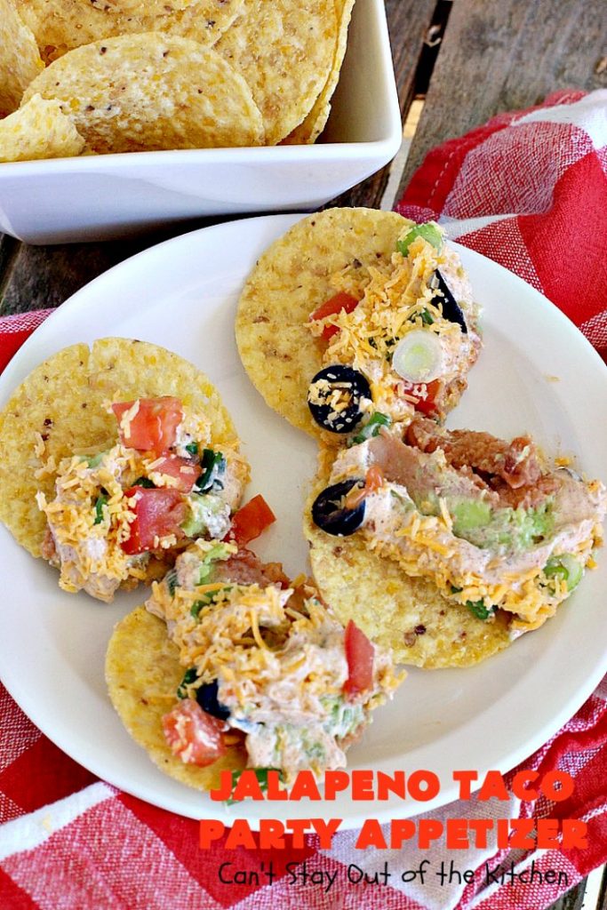 Jalapeno Taco Party Appetizer | Can't Stay Out of the Kitchen | the best #TexMex layered dip ever! This one uses refried beans with jalapenos, #avocados, a sour cream & #taco seasoning layer. Then it's topped with olives, #cheese, green onions and tomatoes. Perfect for #tailgating or #SuperBowl parties. #appetizer