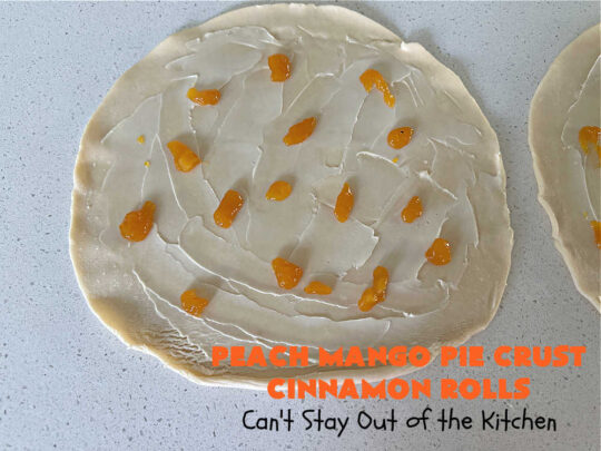 Peach Mango Pie Crust Cinnamon Rolls | Can't Stay Out of the Kitchen | These irresistible sweet treats contain a #PeachMango #fruit spread that's out of this world. This easy #5Ingredient #recipe can be whipped up in a jiffy. Terrific for #breakfast, #brunch or #tailgating snacks. If you enjoy #CinnamonRolls you'll love these little treasures. #cinnamon #PieCrust #PieCrustCinnamonRolls #PeachMangoPieCrustCinnamonRolls