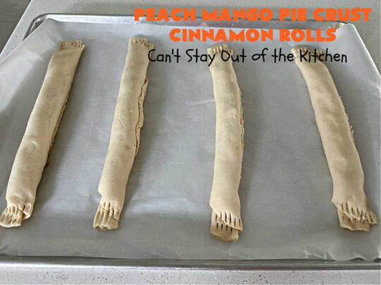 Peach Mango Pie Crust Cinnamon Rolls | Can't Stay Out of the Kitchen | These irresistible sweet treats contain a #PeachMango #fruit spread that's out of this world. This easy #5Ingredient #recipe can be whipped up in a jiffy. Terrific for #breakfast, #brunch or #tailgating snacks. If you enjoy #CinnamonRolls you'll love these little treasures. #cinnamon #PieCrust #PieCrustCinnamonRolls #PeachMangoPieCrustCinnamonRolls