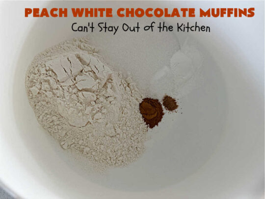 Peach White Chocolate Muffins | Can't Stay Out of the Kitchen | these delectable #muffins are "knock-your-socks-off" good! Every bite is filled with fresh #peaches, #WhiteChocolateChips, #bananas, #applesauce, #cinnamon & #nutmeg. #Chocolate & #FreshPeaches go so well together. Excellent option for #breakfast or #brunch #menus. #holiday #HolidayBreakfast #PeachWhiteChocolateMuffins