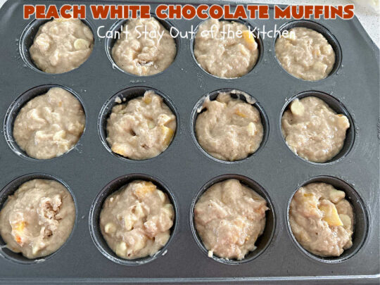 Peach White Chocolate Muffins | Can't Stay Out of the Kitchen | these delectable #muffins are "knock-your-socks-off" good! Every bite is filled with fresh #peaches, #WhiteChocolateChips, #bananas, #applesauce, #cinnamon & #nutmeg. #Chocolate & #FreshPeaches go so well together. Excellent option for #breakfast or #brunch #menus. #holiday #HolidayBreakfast #PeachWhiteChocolateMuffins