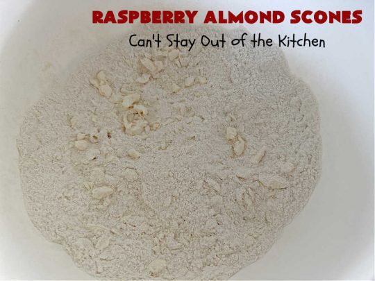 Raspberry Almond Scones | Can't Stay Out of the Kitchen | these delicious #scones are a perfect idea for a company or #holiday #breakfast, like #Thanksgiving or #Christmas. They're filled with fresh #raspberries, sliced #almonds & include #AlmondExtract in the batter as well as the icing. Every bite will rock your world! If you enjoy a sweet treat with your morning coffee, you'll love these! #RaspberryAlmondScones