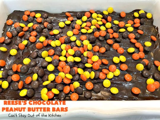 Reese's Chocolate Peanut Butter Bars | Can't Stay Out of the Kitchen | these outrageous #cookies start with an #OatmealCookie & #PeanutButter crust & topping. They have a #chocolate sauce & #ReesesPeanutButterCandies in the middle. Absolutely awesome! #tailgating #brownie #dessert #ChocolateDessert #PeanutButterDessert #ReesesPeanutButterDessert #ReesesChocolatePeanutButterBars