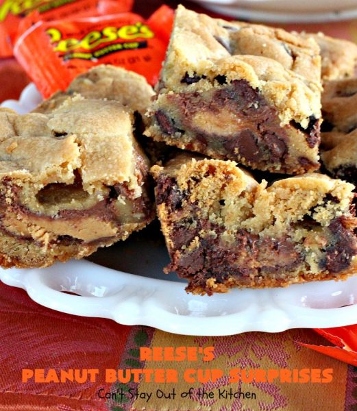 Reese's Peanut Butter Cup Surprises | Can't Stay Out of the Kitchen | these awesome #brownies have #ReesesPeanutButterCups tucked away between two layers of #MrsFieldsChocolateChipCookie dough. They are rich, decadent & absolutely heavenly. Perfect for #tailgating parties, a company #dessert or a #ChristmasCookieExchange. #PeanutButter #PeanutButterCups #chocolate #ReesesPeanutButterCupSurprises