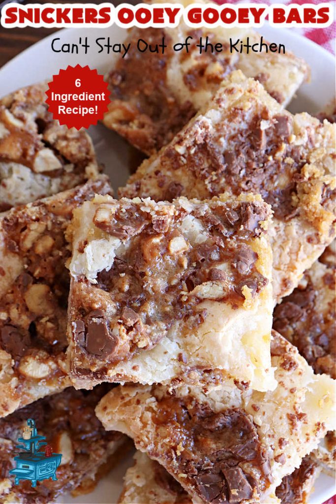 Snickers Ooey Gooey Bars | Can't Stay Out of the Kitchen | these luscious #OoeyGooeyBars contain a #cheesecake layer & they're topped with #SnickersBars for a lovely #chocolate & #PeanutButter flavor that will win over all your family & friends. This 6-ingredient #recipe is perfect for #tailgating parties, potlucks or a #ChristmasCookieExchange. It's easy to whip up & everyone loves them! #holiday #HolidayDessert #SnickersDessert #dessert #brownie #SnickersOoeyGooeyBars