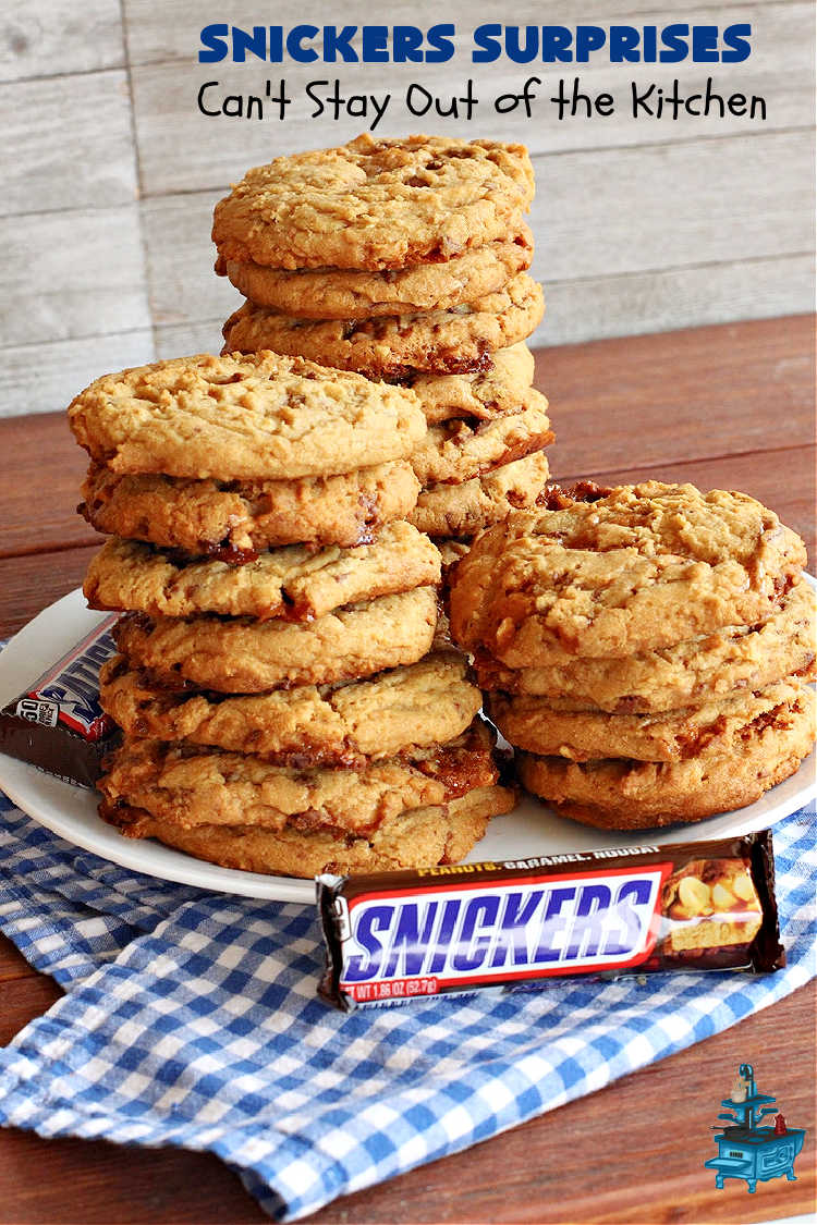 Snickers Surprises | Can't Stay Out of the Kitchen | these scrumptious #PeanutButterCookies include #SnickersBars so they have a little bit of #caramel, #chocolate & #PeanutButter in every bite. You're sure to swoon once you get a taste of these jewels. Perfect for #tailgating, potlucks, backyard BBQs and #holiday #baking. #ChristmasCookieExchange #dessert #ChocolateDessert #SnickersDessert #PeanutButterDessert #CaramelDessert #cookies #SnickersSurprises