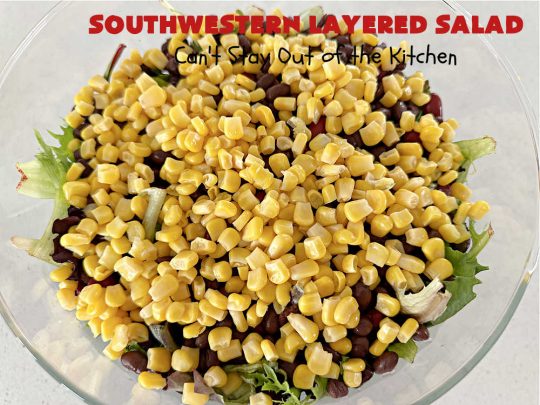 Southwestern Layered Salad | Can't Stay Out of the Kitchen | this scrumptious #LayeredSalad is perfect for company or a crowd since it makes a lot! If you enjoy #TexMex flavor in your #salad or a #TacoSalad this #salad will be right up your alley. The #Southwestern flavors are marvelous & the heartiness of two types of #beans & #corn make this a #MainDishSalad that can't be beat! #bacon #tomatoes #CheddarCheese #Fritos #olives #RanchDressing #FritosCornChips #avocados #pork #SouthwesternLayeredSalad #GlutenFree