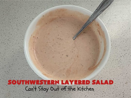 Southwestern Layered Salad | Can't Stay Out of the Kitchen | this scrumptious #LayeredSalad is perfect for company or a crowd since it makes a lot! If you enjoy #TexMex flavor in your #salad or a #TacoSalad this #salad will be right up your alley. The #Southwestern flavors are marvelous & the heartiness of two types of #beans & #corn make this a #MainDishSalad that can't be beat! #bacon #tomatoes #CheddarCheese #Fritos #olives #RanchDressing #FritosCornChips #avocados #pork #SouthwesternLayeredSalad #GlutenFree