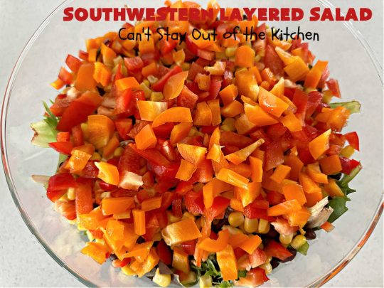 Southwestern Layered Salad | Can't Stay Out of the Kitchen | this scrumptious #LayeredSalad is perfect for company or a crowd since it makes a lot! If you enjoy #TexMex flavor in your #salad or a #TacoSalad this #salad will be right up your alley. The #Southwestern flavors are marvelous & the heartiness of two types of #beans & #corn make this a #MainDishSalad that can't be beat! #bacon #tomatoes #CheddarCheese #Fritos #olives #RanchDressing #FritosCornChips #avocados #pork #SouthwesternLayeredSalad #GlutenFree