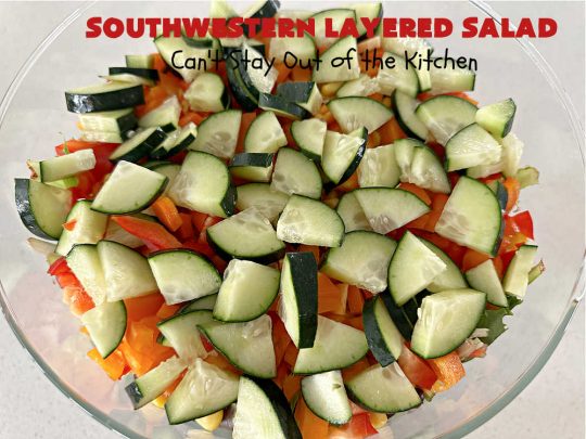 Southwestern Layered Salad | Can't Stay Out of the Kitchen | this scrumptious #LayeredSalad is perfect for company or a crowd since it makes a lot! If you enjoy #TexMex flavor in your #salad or a #TacoSalad this #salad will be right up your alley. The #Southwestern flavors are marvelous & the heartiness of two types of #beans & #corn make this a #MainDishSalad that can't be beat! #bacon #tomatoes #CheddarCheese #Fritos #olives #RanchDressing #FritosCornChips #avocados #pork #SouthwesternLayeredSalad #GlutenFree