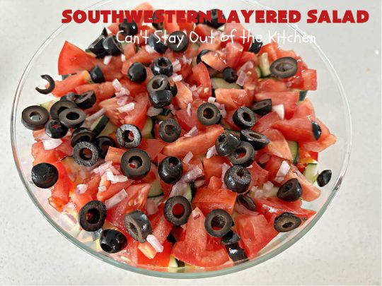 Southwestern Layered Salad | Can't Stay Out of the Kitchen | this scrumptious #LayeredSalad is perfect for company or a crowd since it makes a lot! If you enjoy #TexMex flavor in your #salad or a #TacoSalad this #salad will be right up your alley. The #Southwestern flavors are marvelous & the heartiness of two types of #beans & #corn make this a #MainDishSalad that can't be beat! #bacon #tomatoes #CheddarCheese #Fritos #olives #RanchDressing #FritosCornChips #avocados #pork #SouthwesternLayeredSalad #GlutenFree