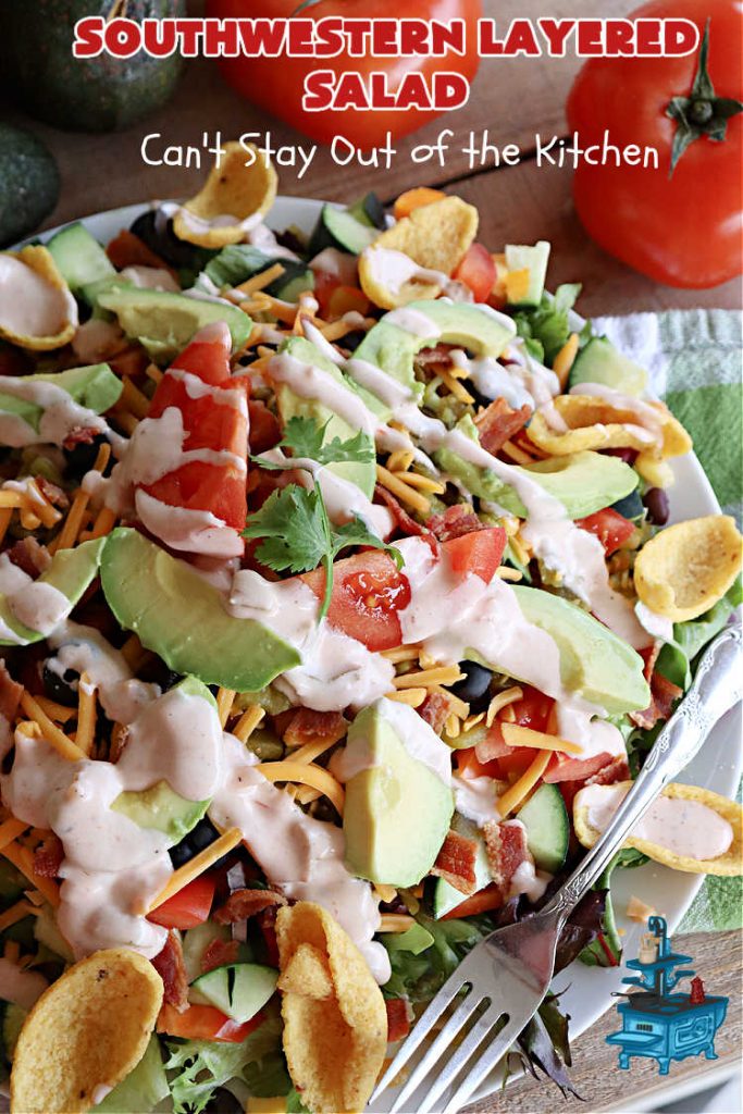 Southwestern Layered Salad | Can't Stay Out of the Kitchen | this scrumptious #LayeredSalad is perfect for company or a crowd since it makes a lot! If you enjoy #TexMex flavor in your #salad or a #TacoSalad this #salad will be right up your alley. The #Southwestern flavors are marvelous & the heartiness of two types of #beans & #corn make this a #MainDishSalad that can't be beat! #bacon #tomatoes #CheddarCheese #Fritos #olives #RanchDressing #FritosCornChips #avocados #pork #SouthwesternLayeredSalad #GlutenFree