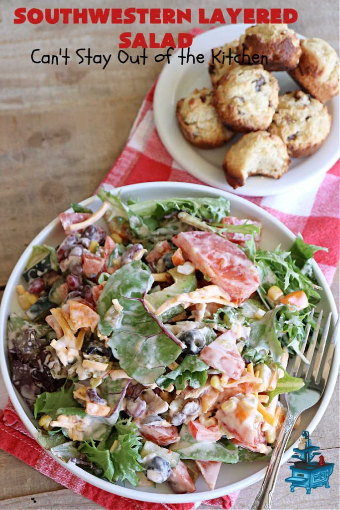 Southwestern Layered Salad | Can't Stay Out of the Kitchen | this scrumptious #LayeredSalad is perfect for company or a crowd since it makes a lot! If you enjoy #TexMex flavor in your #salad or a #TacoSalad this #salad will be right up your alley. The #Southwestern flavors are marvelous & the heartiness of two types of #beans & #corn make this a #MainDishSalad that can't be beat! #bacon #tomatoes #CheddarCheese #Fritos #olives #RanchDressing #FritosCornChips #avocados #pork #SouthwesternLayeredSalad #GlutenFree